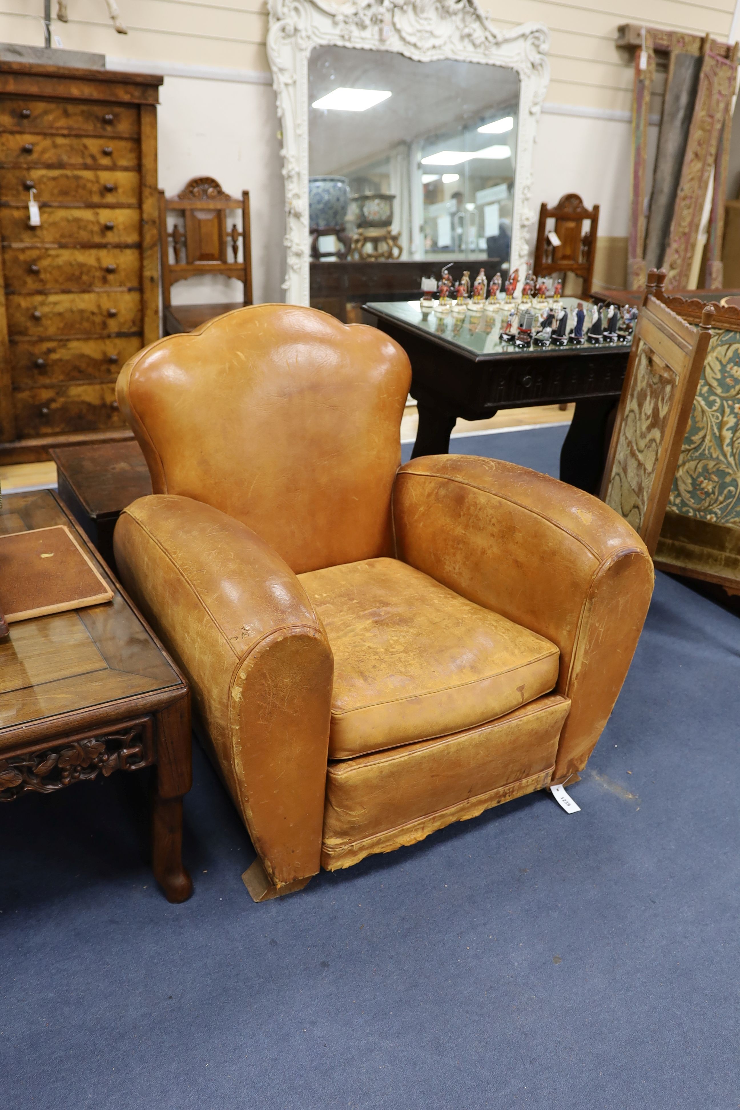 A pair of mid 20th century French tan leather club armchairs, width 90cm, depth 84cm, height 80cm